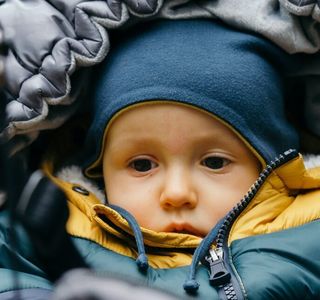 baby in blue and yellow jacket