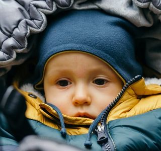 baby in blue and yellow jacket