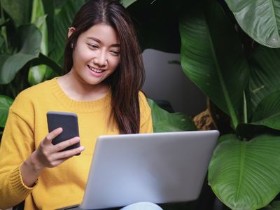 asian woman excited with sale promotion on website shop on laptop