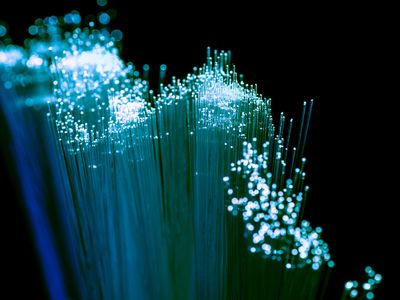Close up of shiny light blue fiber optics background, communication technology