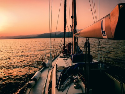 white and black sailboat during sunset