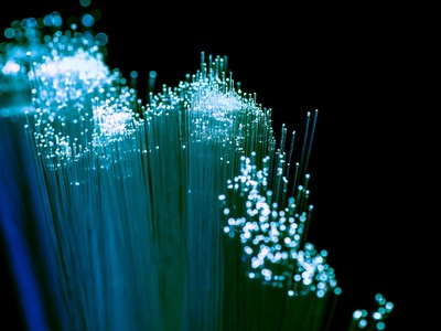 Close up of shiny light blue fiber optics background, communication technology