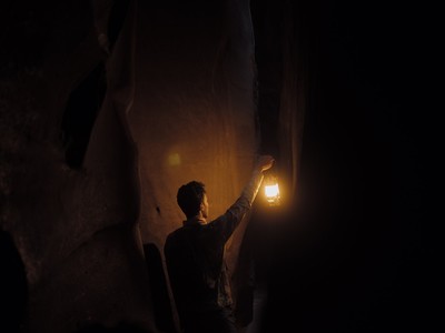 a man holding a lantern in the dark