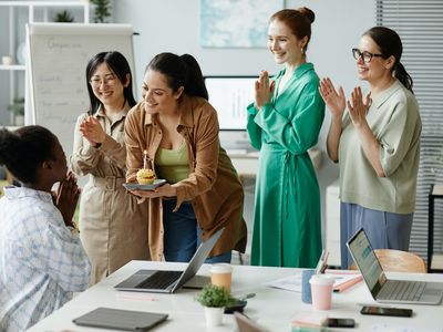 Businesswomen congratulating their colleague at office