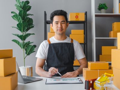 Young asian sme business man in apron working at warehouse home office freelancer retail logistic