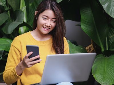 asian woman excited with sale promotion on website shop on laptop