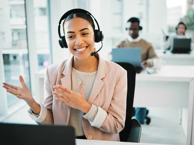 Happy woman, laptop and call center with headphones consulting in customer service or telemarketing