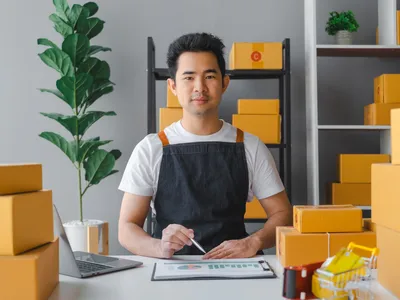 Young asian sme business man in apron working at warehouse home office freelancer retail logistic