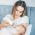 Mother feeding a newborn baby from bottle at home.