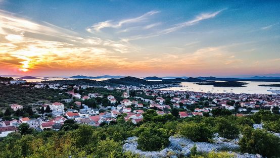 Amazing sunset sky over coastal town of Murter in Croatia.